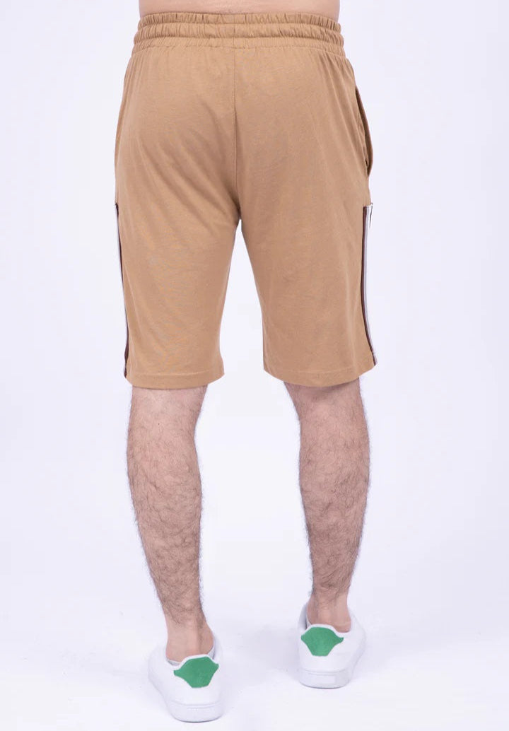 Beige shorts with a side stripe worn by a person on a white background