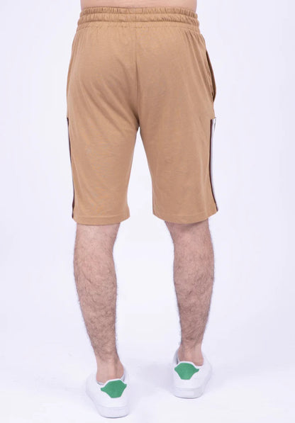 Beige shorts with a side stripe worn by a person on a white background