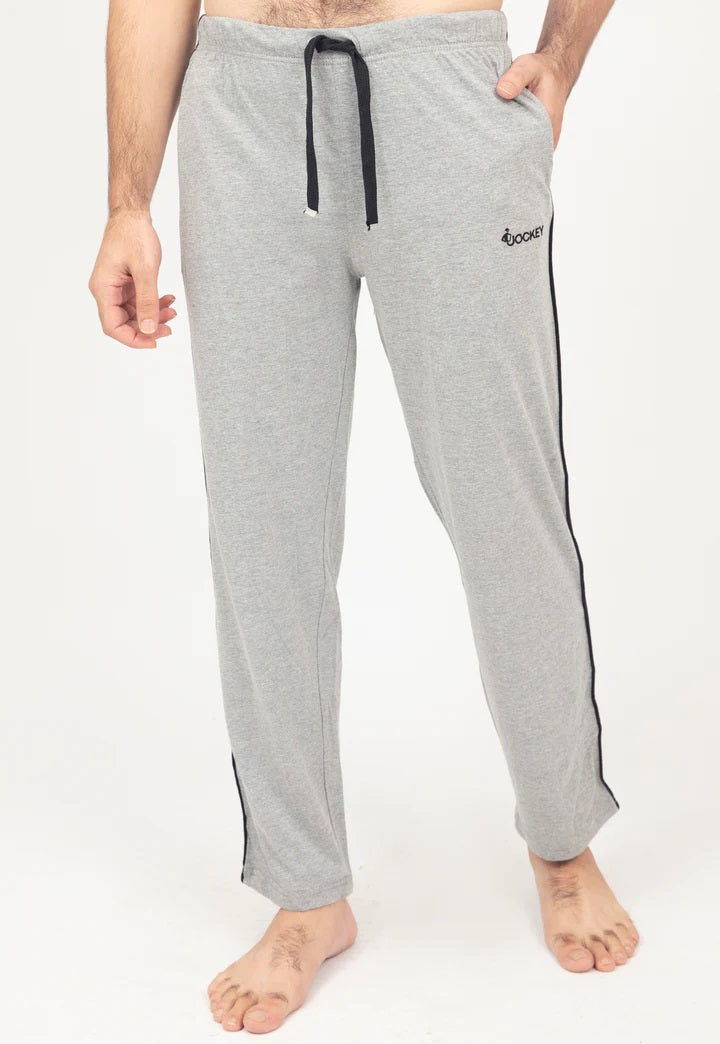 Gray pajama pants with a black drawstring and side stripe on a white background