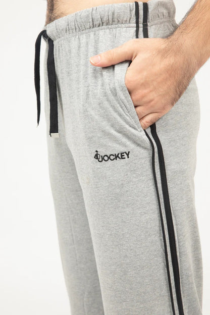 Gray sweatpants with black stripes and a logo on a white background